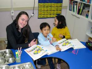 Allison teaching math to two of her students.