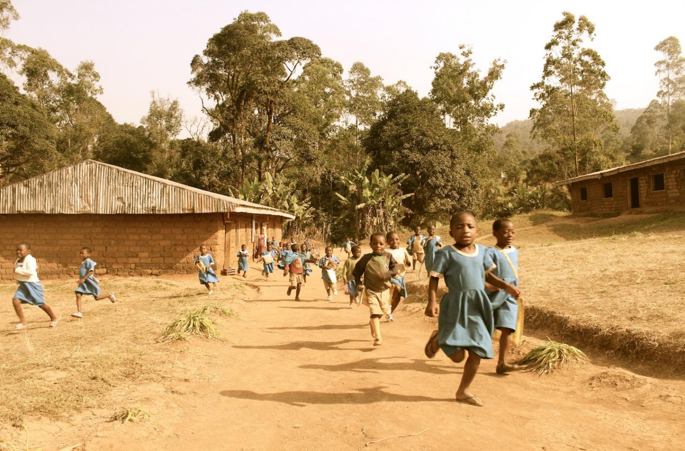  Students from Wabane District in Cameroon running to participate in workshops.