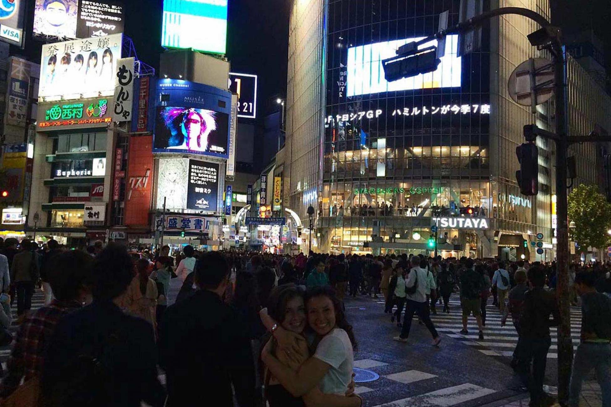 Gillian celebrates a safe arrival with her friend in Shibuya, Tokyo.