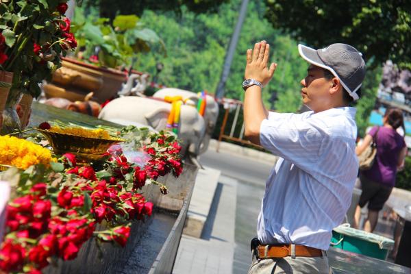 A man prays at the Ganesha Shrine in Bangkok. 