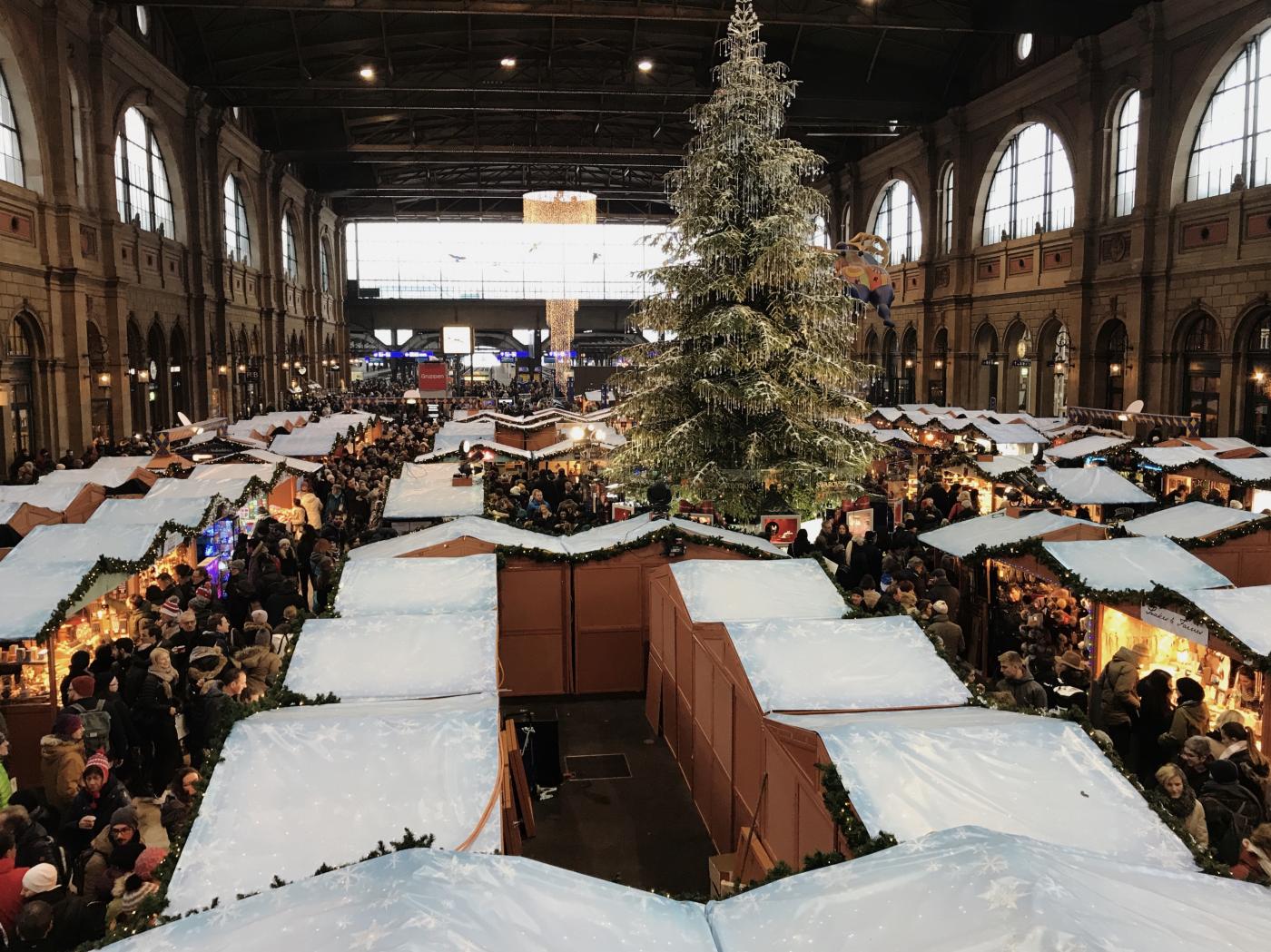 The Swarovski studded tree illuminates Zürich’s largest indoor market. 