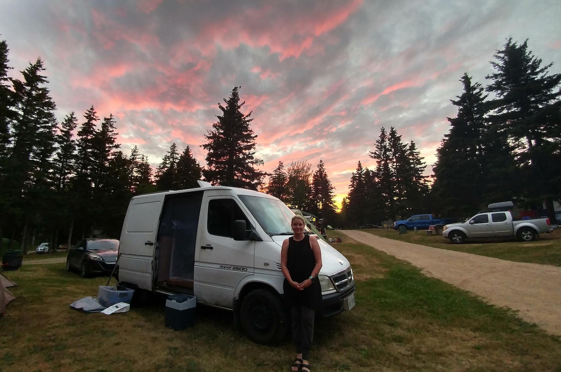 The author&#039;s partner in front of their van. 